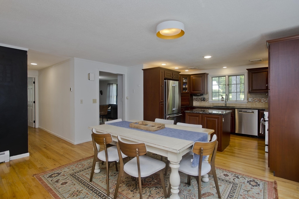 581 Burts Pit Road Northampton, MA 01062 - Photo 12 of 35 a view of a dining room with furniture and wooden floor