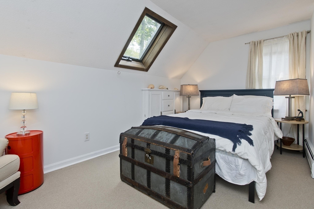 581 Burts Pit Road Northampton, MA 01062 - Photo 22 of 35 a bedroom with a bed and a lamp