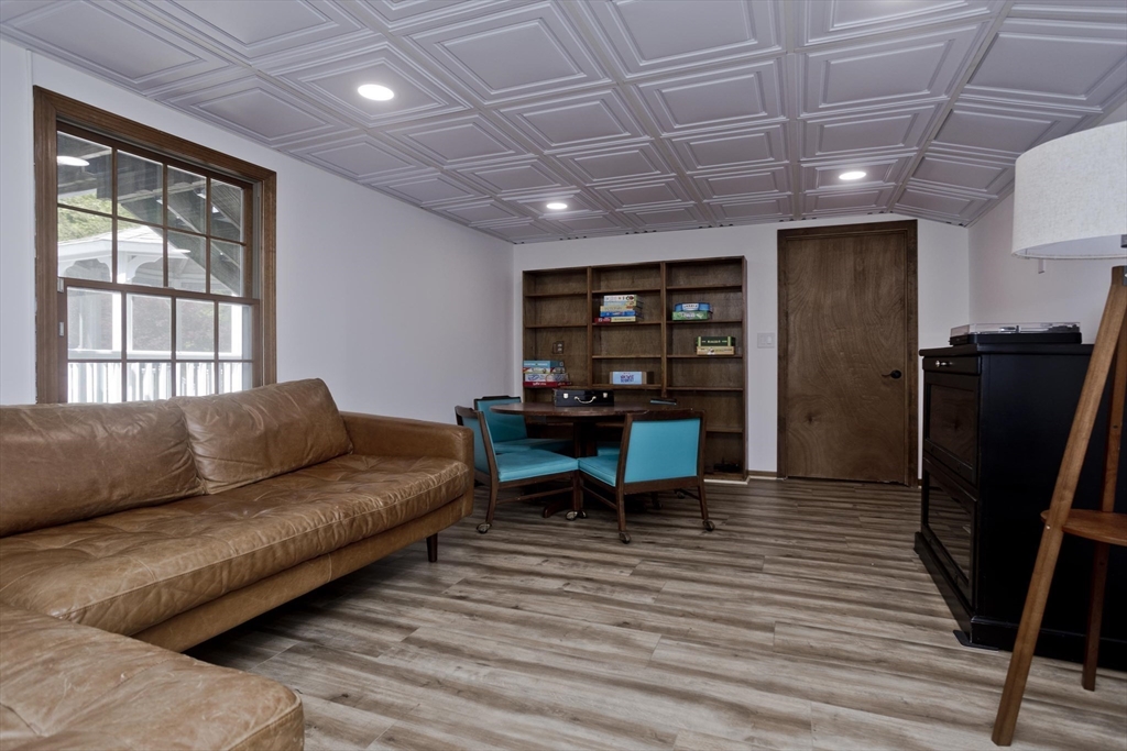 581 Burts Pit Road Northampton, MA 01062 - Photo 25 of 35 a living room with furniture and a dining table with wooden floor