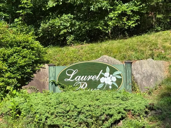 a sign that is sitting on a brick wall