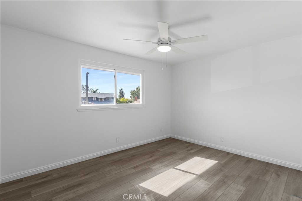 10672 Finch Avenue Rancho Cucamonga, CA 91737 - Photo 28 of 39 an empty room with a window and wooden floor