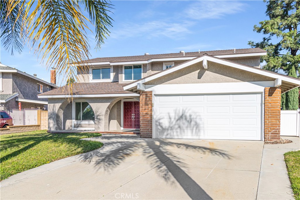10672 Finch Avenue Rancho Cucamonga, CA 91737 - Photo 3 of 39 a front view of a house with a yard and potted plants