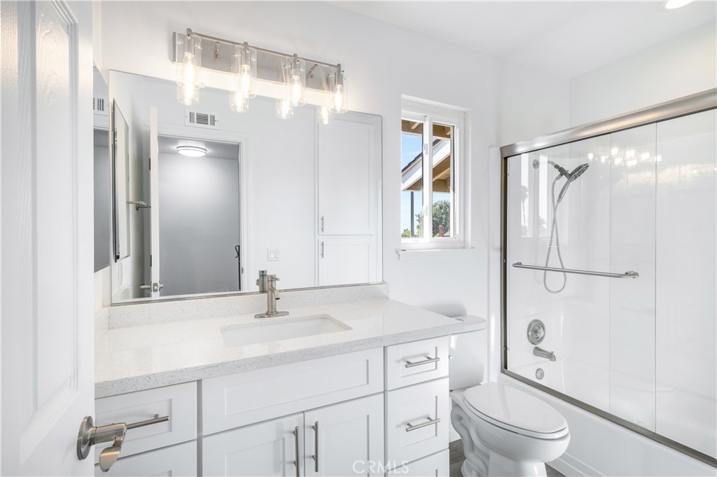 10672 Finch Avenue Rancho Cucamonga, CA 91737 - Photo 33 of 39 a bathroom with a sink a toilet and a mirror