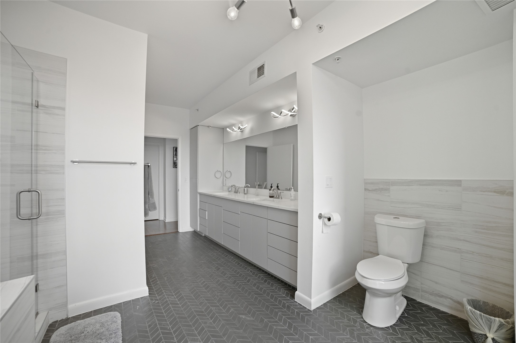 54 Rainey Street, Unit 1018 Austin, TX 78701 - Photo 18 of 32 a bathroom with a toilet sink and mirror