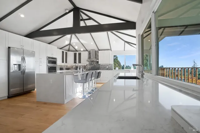 a view of a kitchen with a sink and staircase
