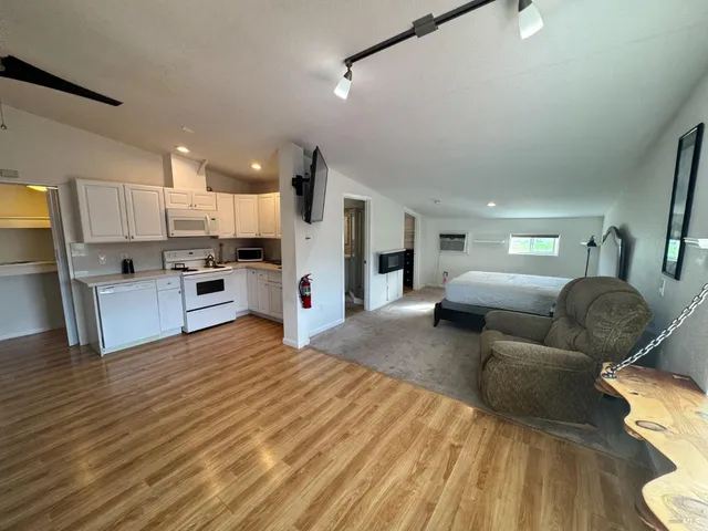 a living room with furniture and kitchen view