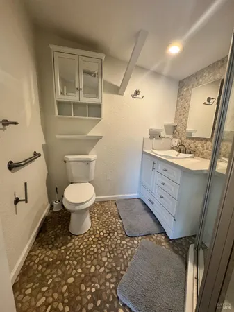 a bathroom with a toilet sink and mirror