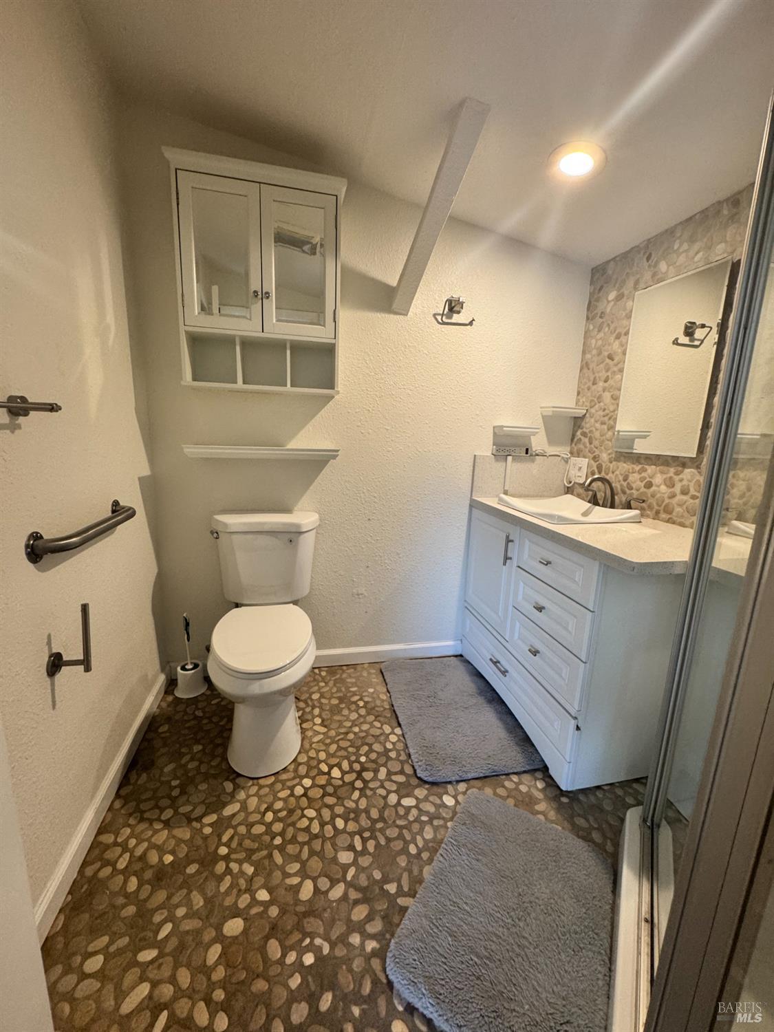 3753 Santa Rosa Avenue, Unit E Santa Rosa, CA 95407 - Photo 11 of 16 a bathroom with a toilet sink and mirror