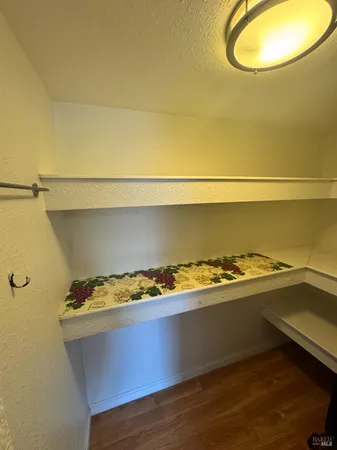 a view of water heater room with wooden floor