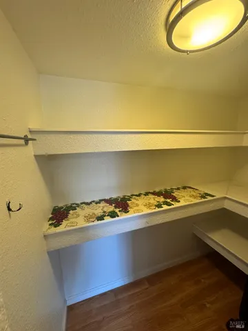 a view of water heater room with wooden floor