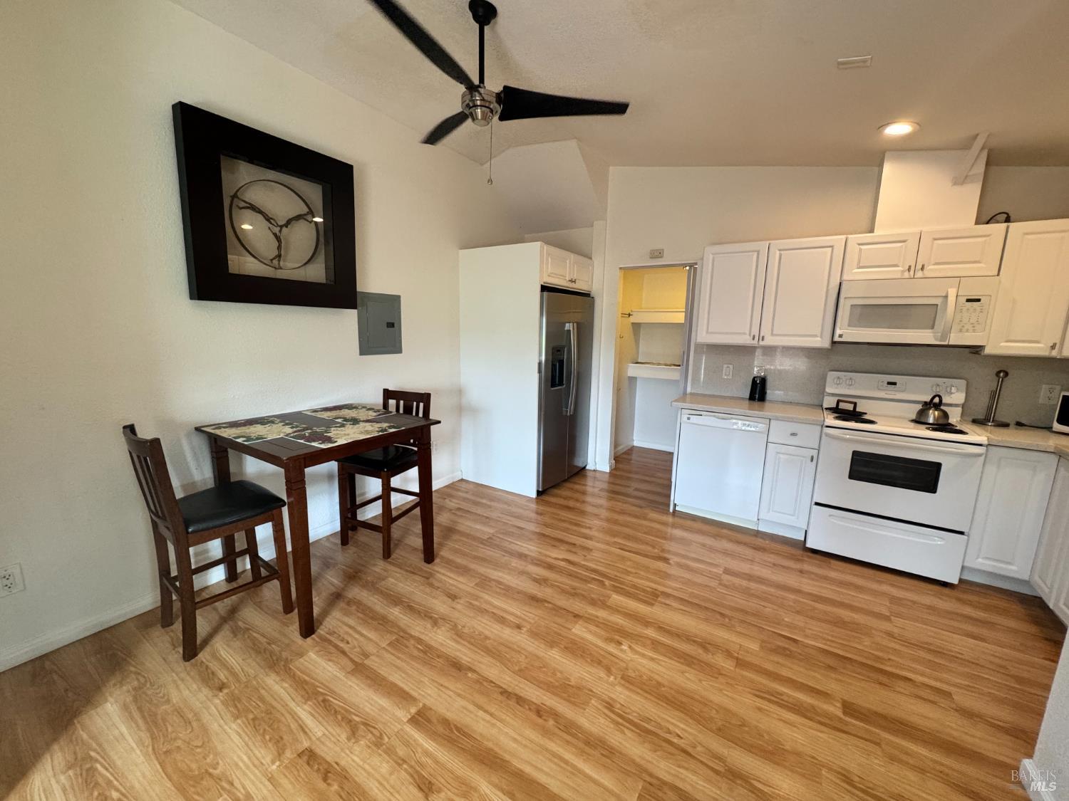 3753 Santa Rosa Avenue, Unit E Santa Rosa, CA 95407 - Photo 2 of 16 a kitchen with stainless steel appliances wooden floor and a refrigerator