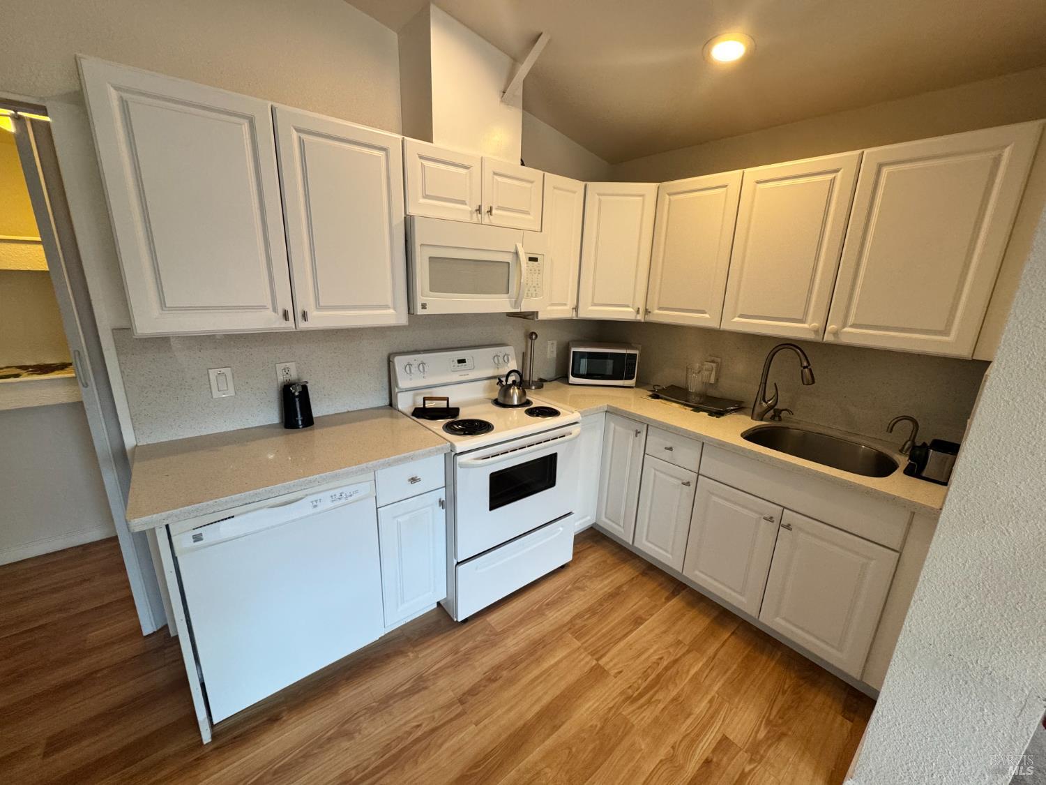 3753 Santa Rosa Avenue, Unit E Santa Rosa, CA 95407 - Photo 4 of 16 a kitchen with white cabinets sink and appliances