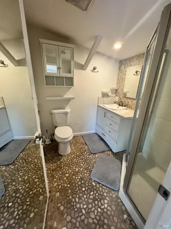 a bathroom with a sink toilet and shower