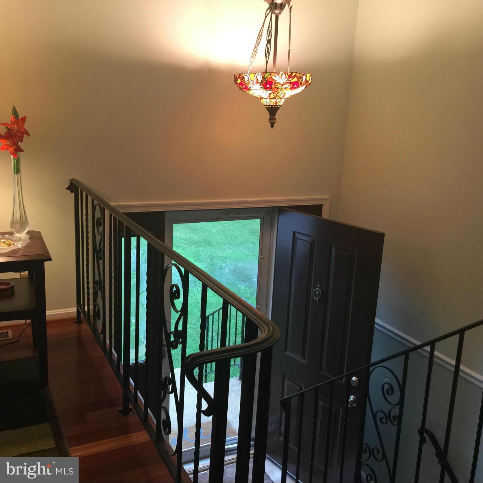 14909 Schall Road Accokeek, MD 20607 - Photo 2 of 22 a view of a hallway with wooden floor and staircase