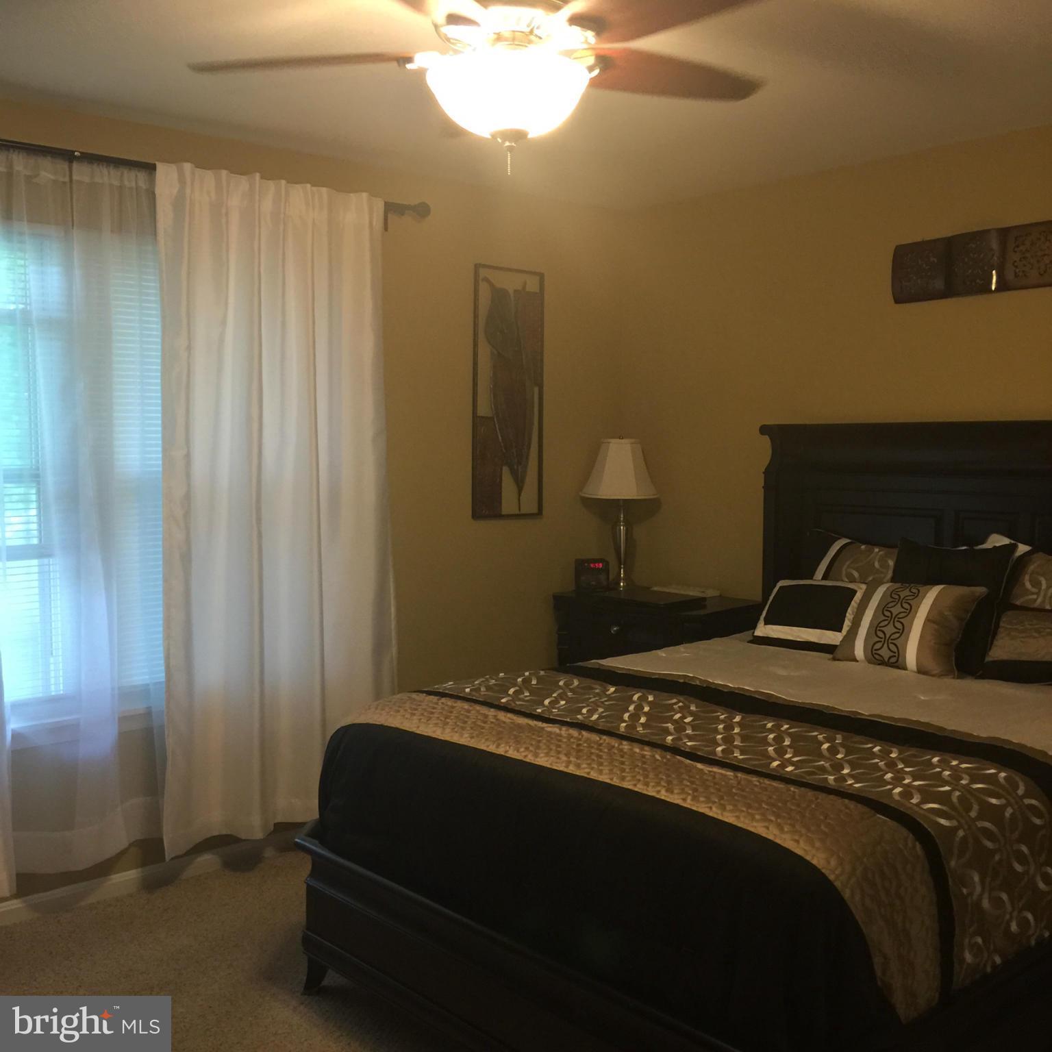 14909 Schall Road Accokeek, MD 20607 - Photo 12 of 22 a bedroom with a bed and a window