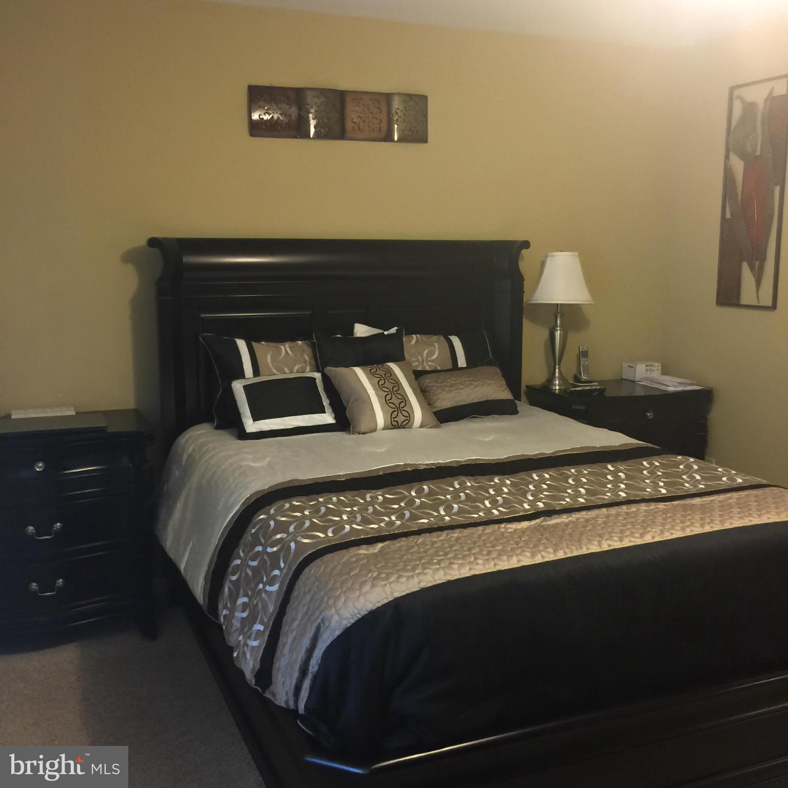 14909 Schall Road Accokeek, MD 20607 - Photo 13 of 22 a bedroom with a bed and wooden floor
