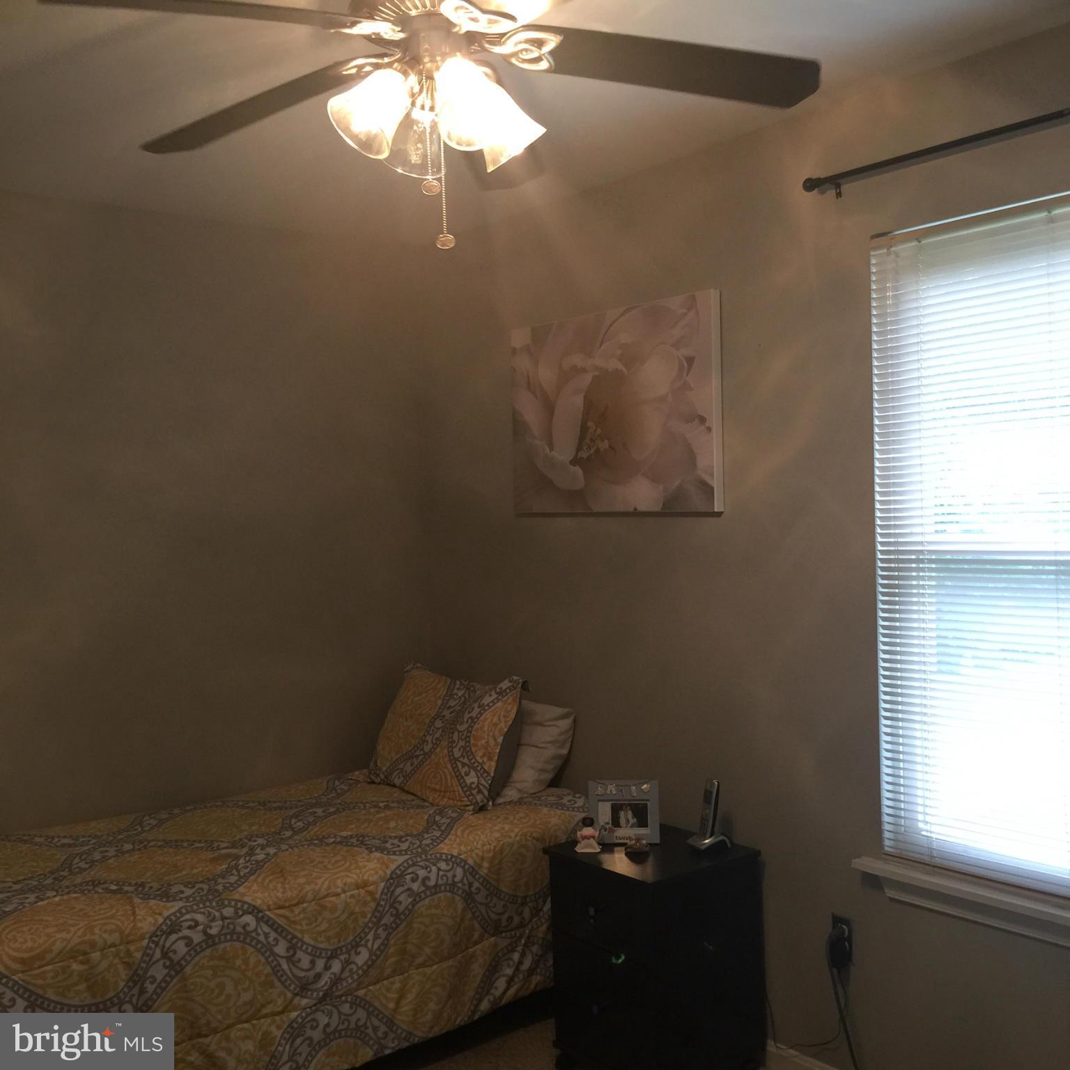14909 Schall Road Accokeek, MD 20607 - Photo 14 of 22 a bed sitting in a bedroom next to a window