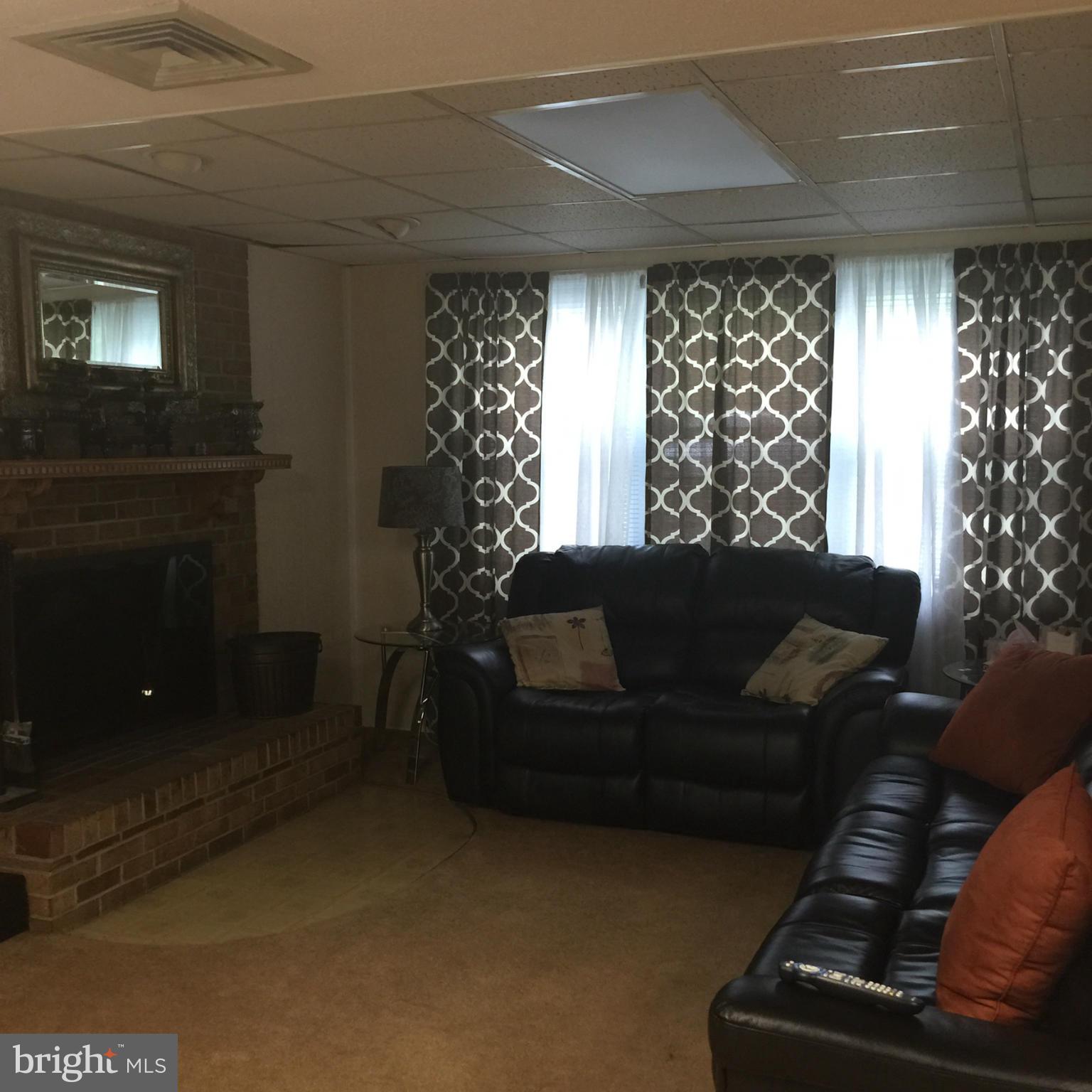 14909 Schall Road Accokeek, MD 20607 - Photo 15 of 22 a living room with furniture and a fireplace