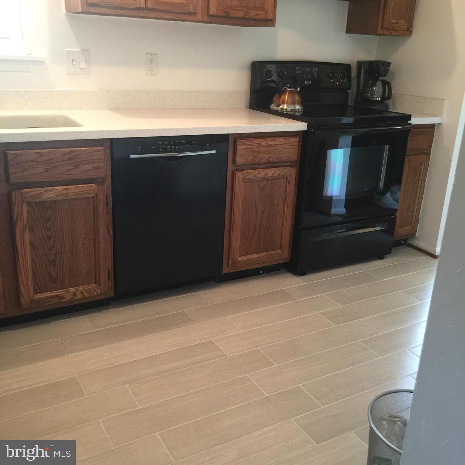 14909 Schall Road Accokeek, MD 20607 - Photo 21 of 22 a kitchen with a sink and a stove