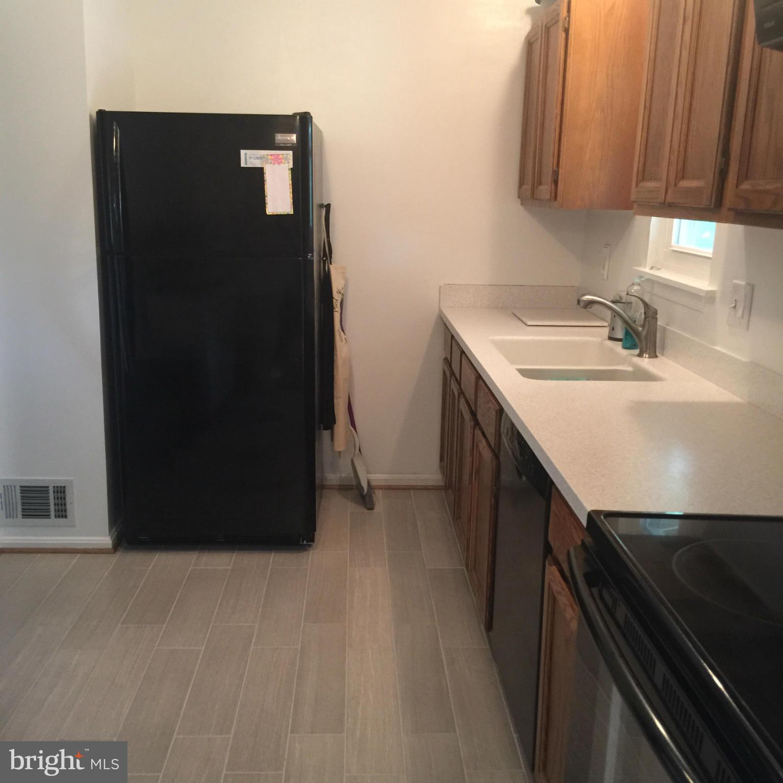 14909 Schall Road Accokeek, MD 20607 - Photo 22 of 22 a kitchen with a sink and a refrigerator