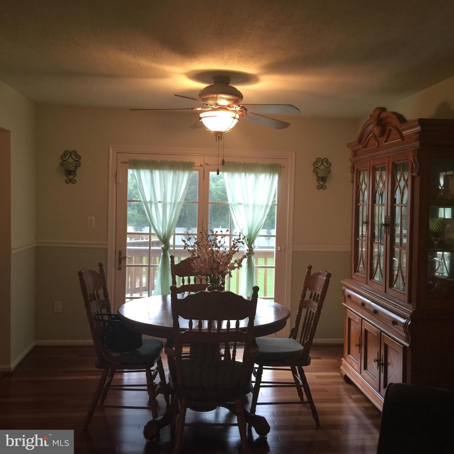 14909 Schall Road Accokeek, MD 20607 - Photo 4 of 22 a view of a dining room with furniture window and wooden floor