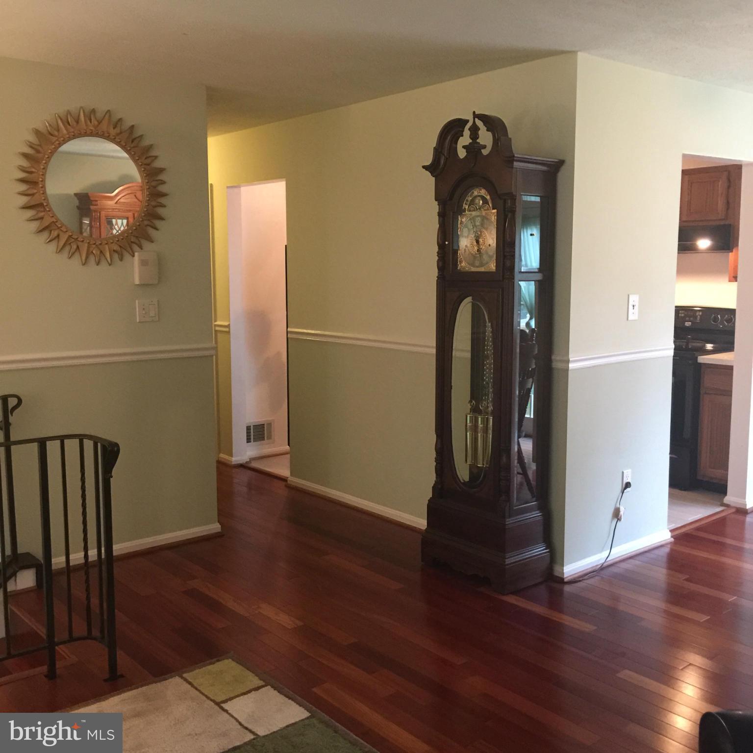 14909 Schall Road Accokeek, MD 20607 - Photo 8 of 22 a view of a hallway with wooden floor and entryway