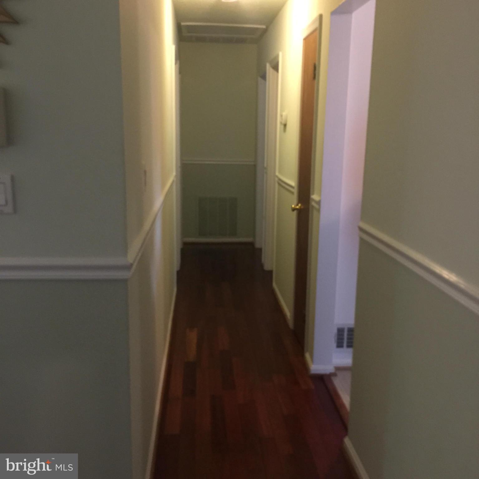 14909 Schall Road Accokeek, MD 20607 - Photo 9 of 22 a view of a hallway with a wooden floor