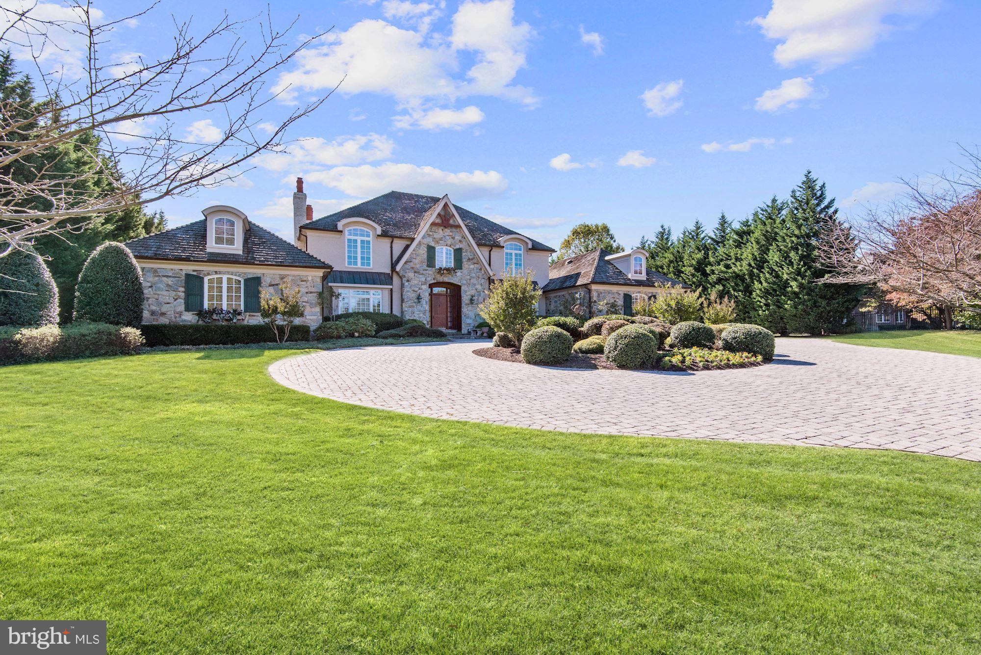 11400 Glen Road Potomac, MD 20854 - Photo 2 of 30 a front view of a house with a yard and garage