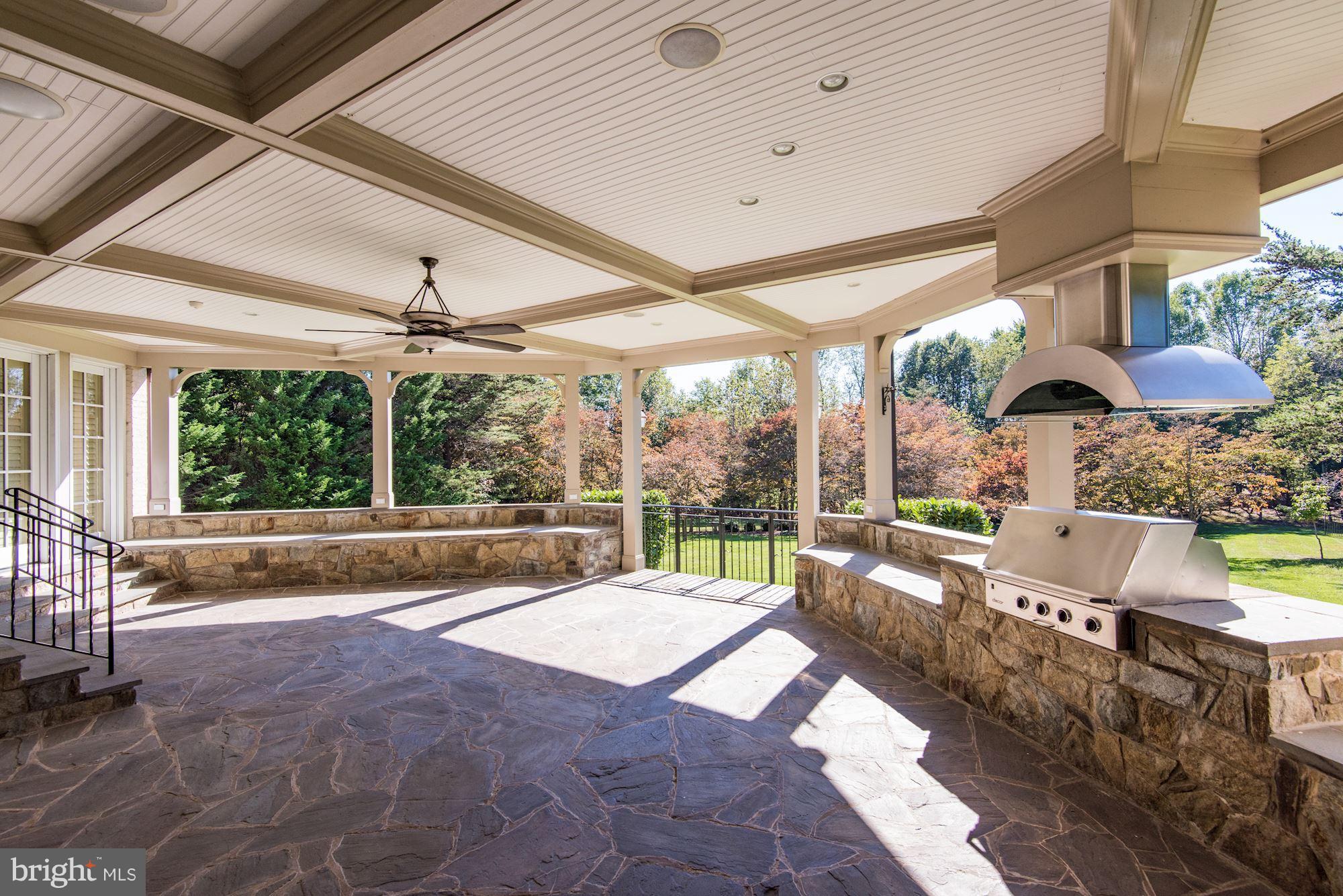 11400 Glen Road Potomac, MD 20854 - Photo 11 of 30 a view of a patio with a table chairs flat screen tv