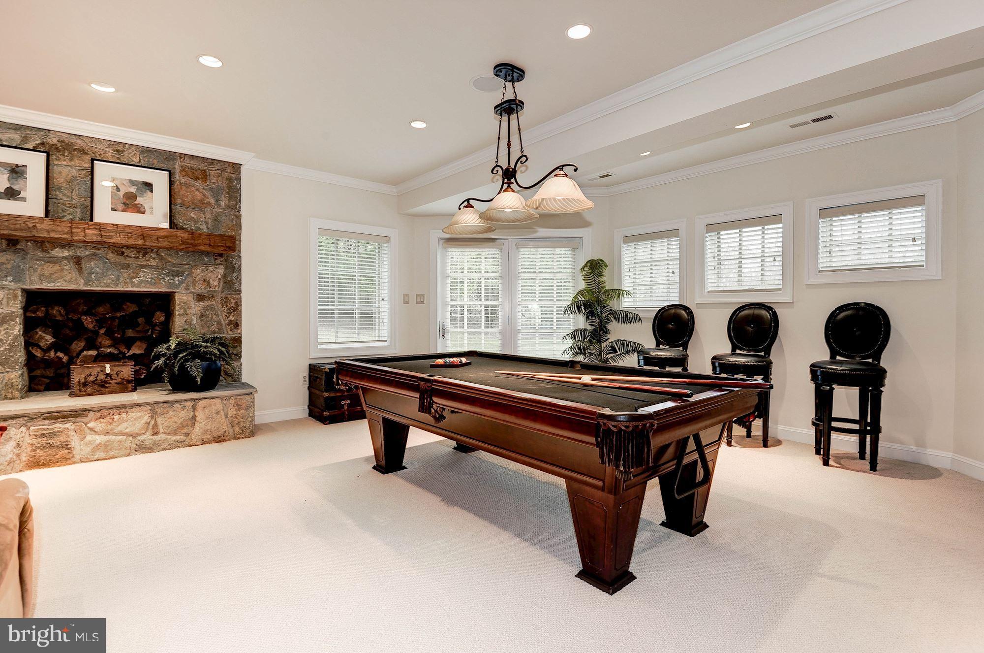 11400 Glen Road Potomac, MD 20854 - Photo 20 of 30 a living room with furniture a fireplace and a chandelier