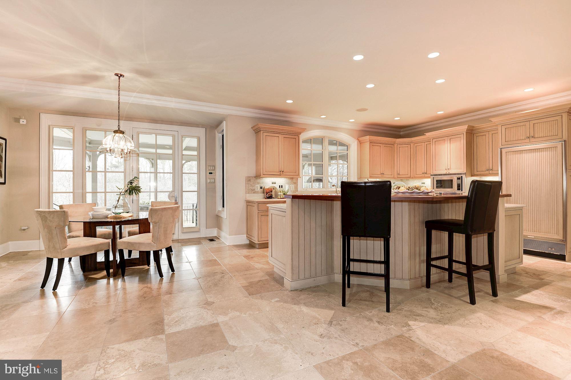 11400 Glen Road Potomac, MD 20854 - Photo 8 of 30 a dining area with stainless steel appliances kitchen island granite countertop furniture and a dining table