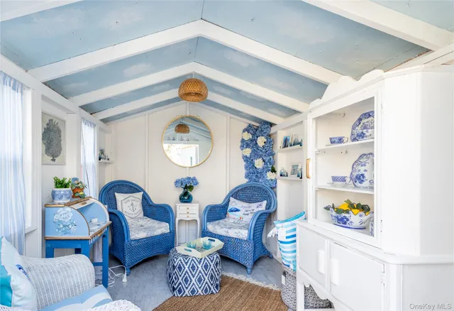 a living room with furniture and a clock