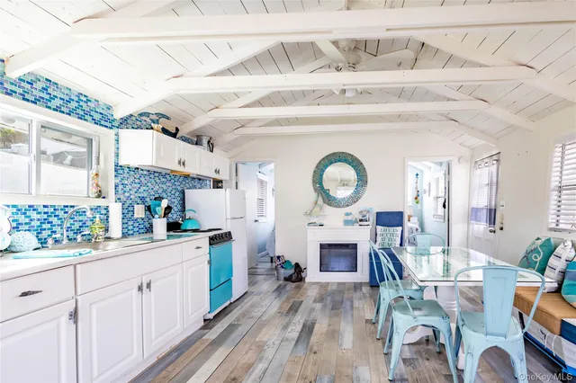 a living room with furniture a fireplace and a large window