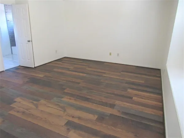 an empty room with wooden floor