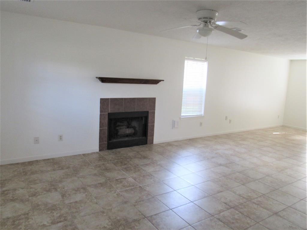 18822 Timber Way Drive Humble, TX 77346 - Photo 4 of 15 an empty room with windows and fireplace