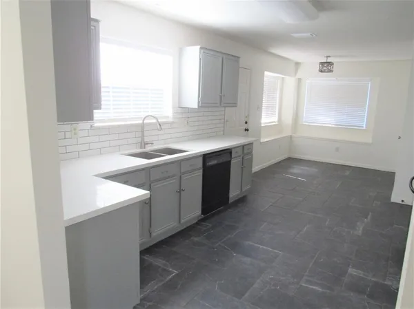 a kitchen with a sink stove and cabinets