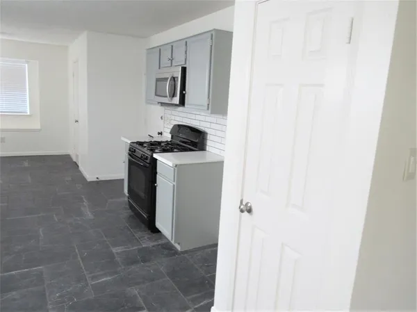 a kitchen with a stove and a refrigerator