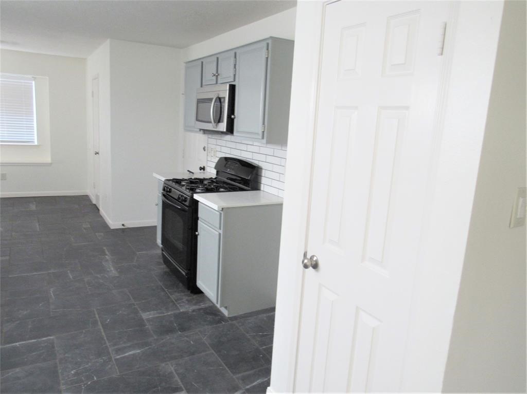 18822 Timber Way Drive Humble, TX 77346 - Photo 6 of 15 a kitchen with a stove and a refrigerator