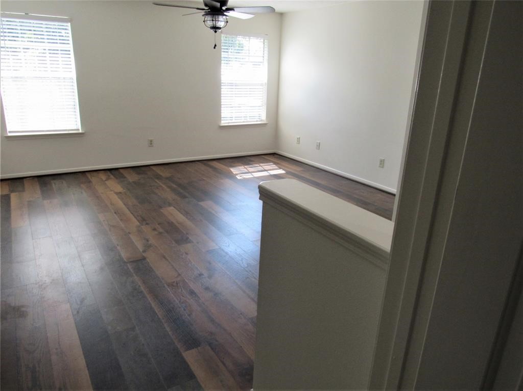 18822 Timber Way Drive Humble, TX 77346 - Photo 8 of 15 an empty room with wooden floor and windows