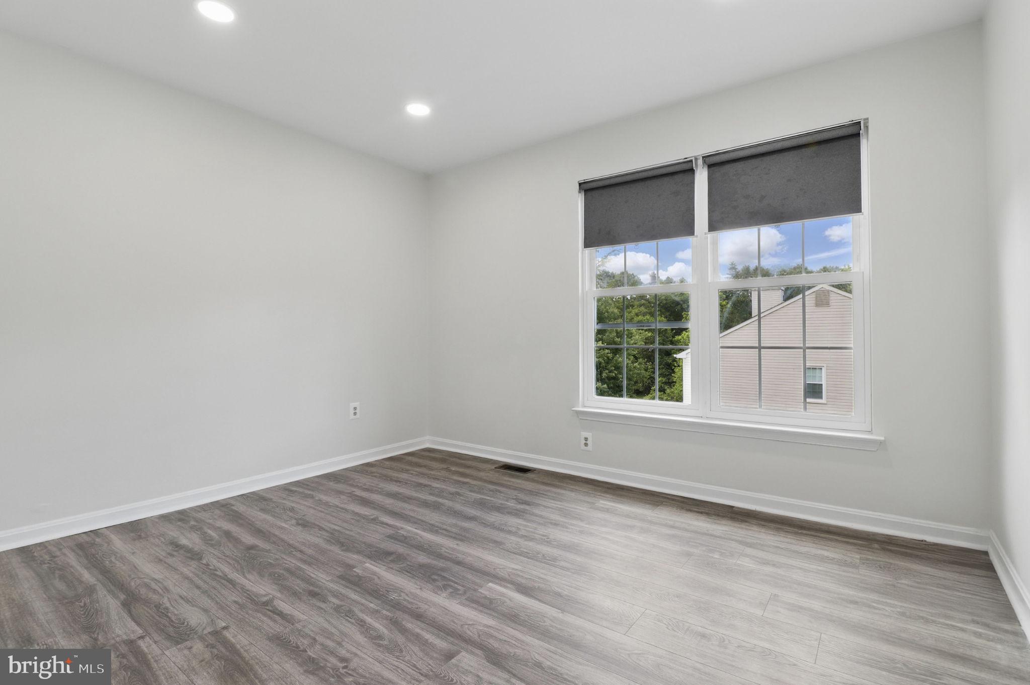 9482 Ridgeview Drive Columbia, MD 21046 - Photo 54 of 86 a view of empty room with wooden floor and fan