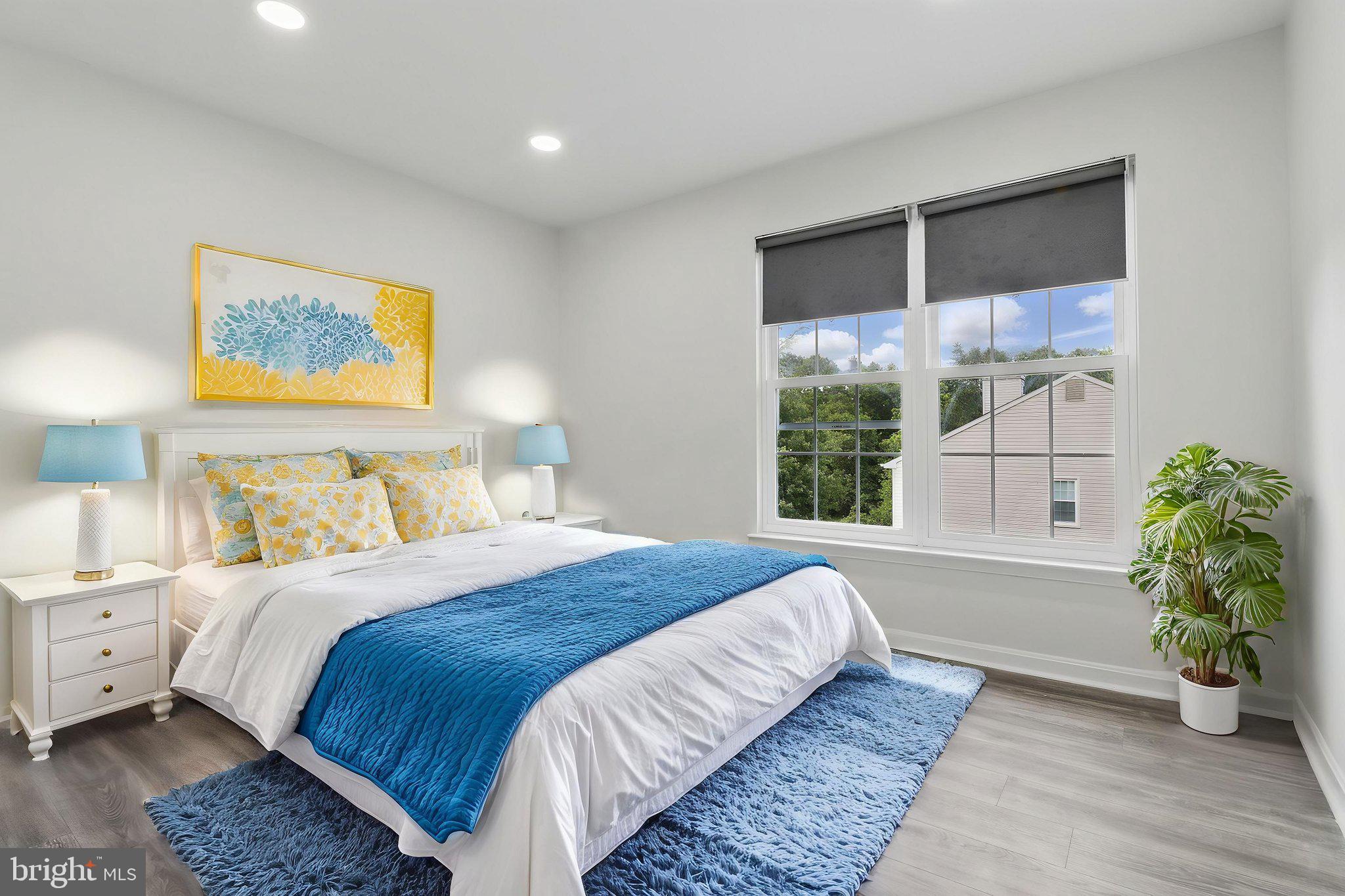 9482 Ridgeview Drive Columbia, MD 21046 - Photo 55 of 86 a bedroom with a large bed and a potted plant