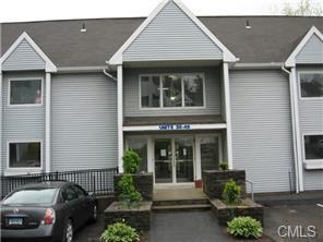 1 Beaver Brook Road, Unit 44 Danbury, CT 06810 - Photo 1 of 1 a front view of a house with a garden
