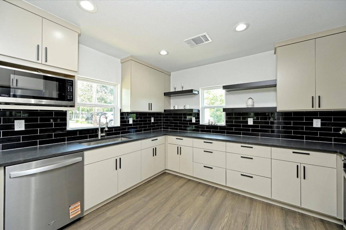 710 East 2nd Street Elgin, TX 78621 - Photo 11 of 30 a kitchen with granite countertop a sink and cabinets