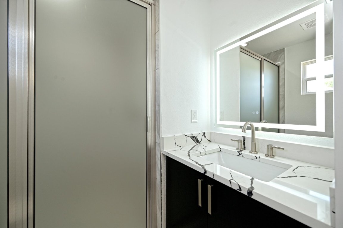 710 East 2nd Street Elgin, TX 78621 - Photo 19 of 30 a bathroom with double sink and a mirror
