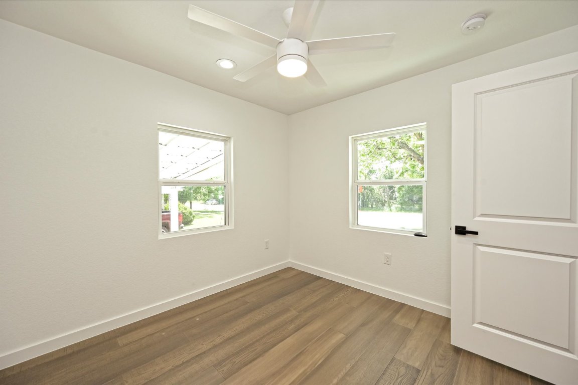710 East 2nd Street Elgin, TX 78621 - Photo 21 of 30 a view of an empty room with wooden floor and a window