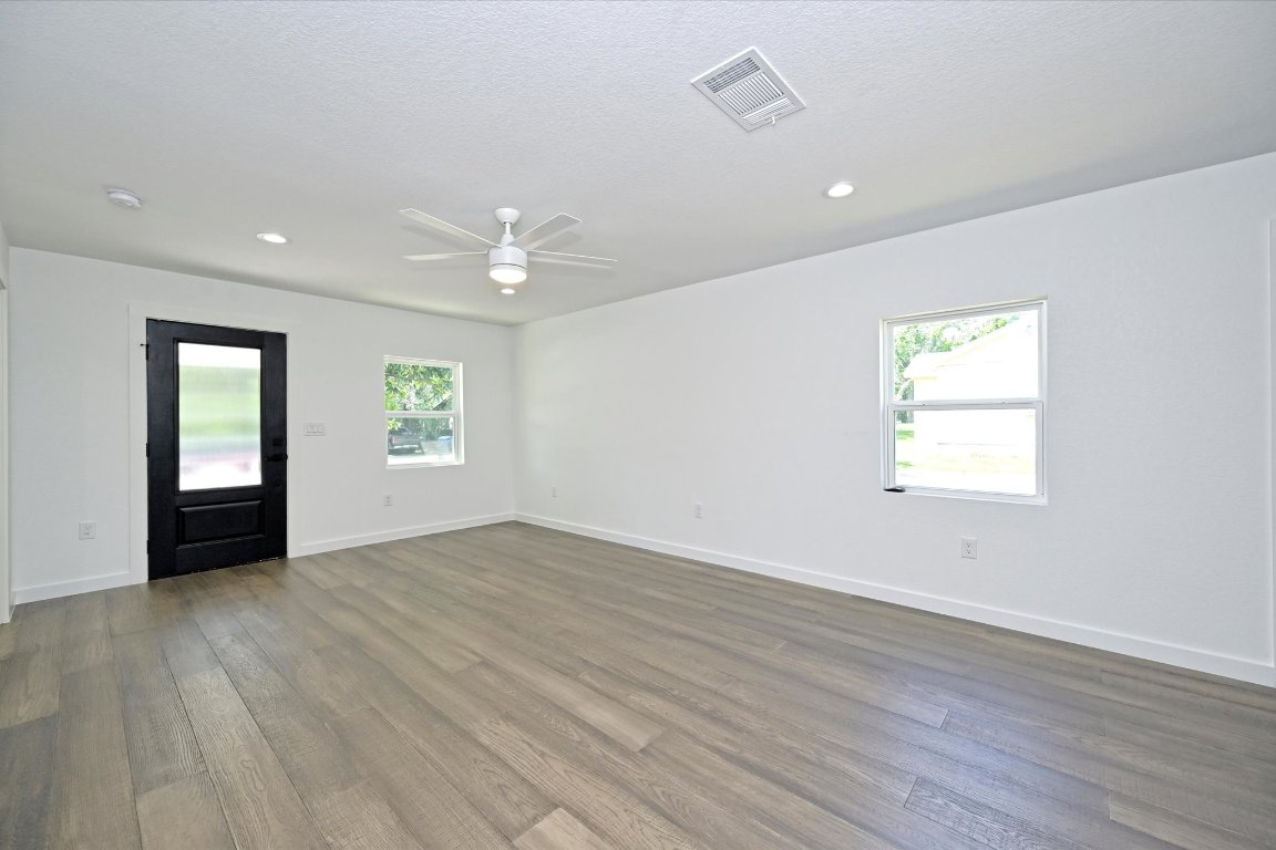 710 East 2nd Street Elgin, TX 78621 - Photo 4 of 30 wooden floor in an empty room with a window