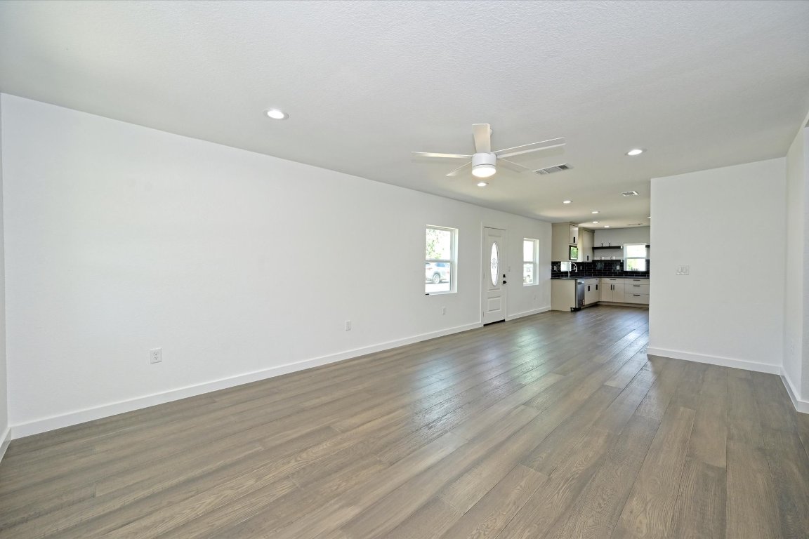710 East 2nd Street Elgin, TX 78621 - Photo 7 of 30 wooden floor in an empty room with a window