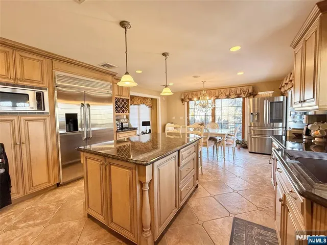 a kitchen with stainless steel appliances granite countertop a sink and cabinets