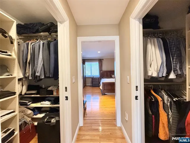 a view of walk in closet with clothes and shoes