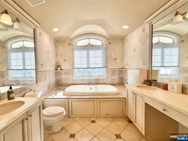 a view of a bathroom with a sink a toilet and a window